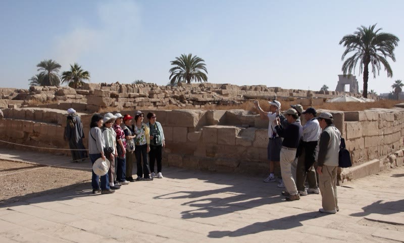 Visitors photographing and walking through Karnak